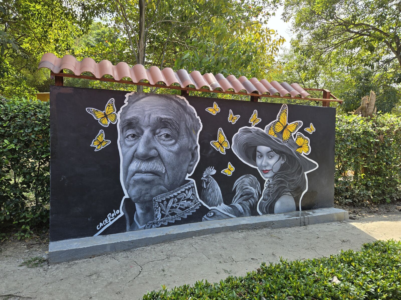 Historic faces and fluttering butterflies whisper Colombia’s rich stories beneath the vibrant sun.