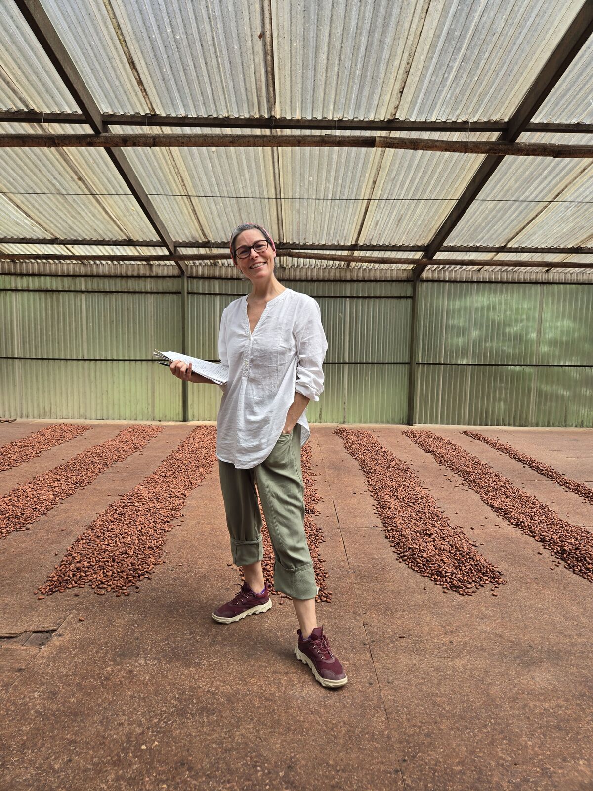 Learning the art of cacao drying, surrounded by rich aromas and vibrant bean rows.